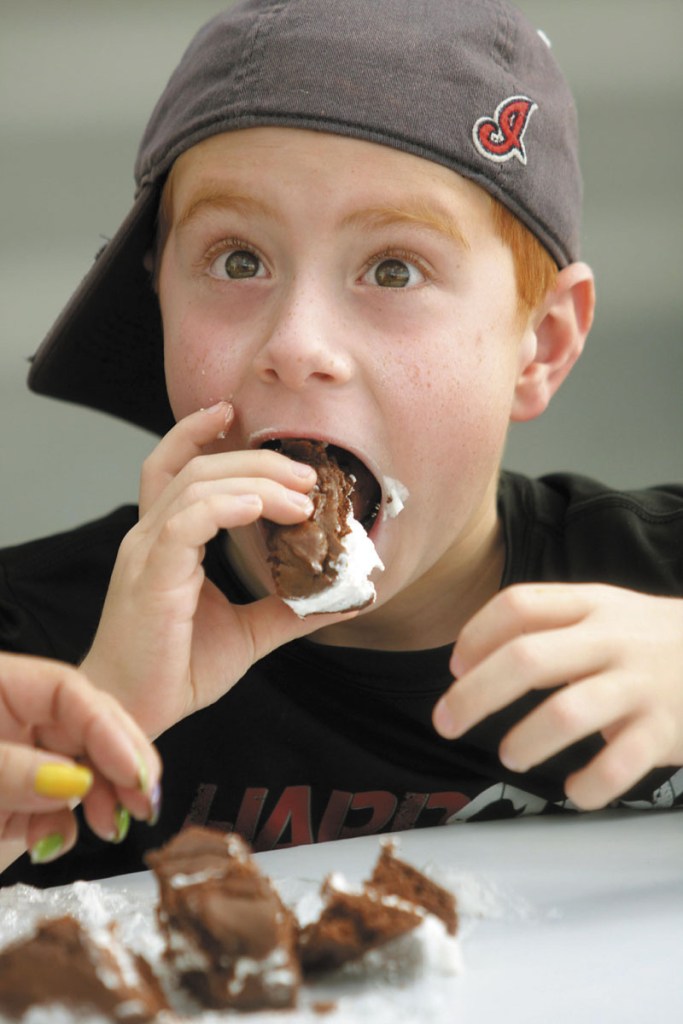 A BIG TASTE: Noah Mitchell, 8, of Solon, Ohio, takes a bite of a whoopie pie from T&B’s Outback Tavern during the 19th annual Taste of Greater Waterville on Wednesday night. Mitchell is in Maine visiting his grandparents for the summer.