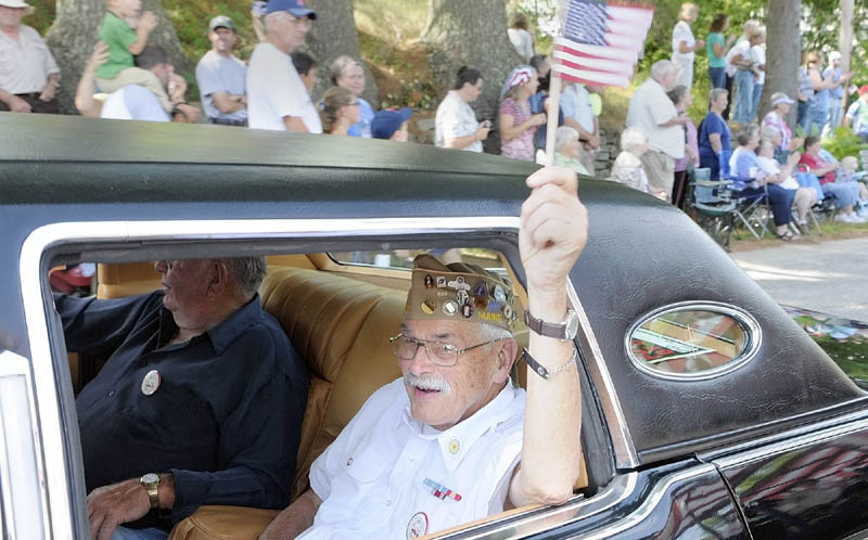 Henry Chapman waves a flag out the window as he rides in the parade to celebrate the Town Of Washington's bicentennial on Saturday.