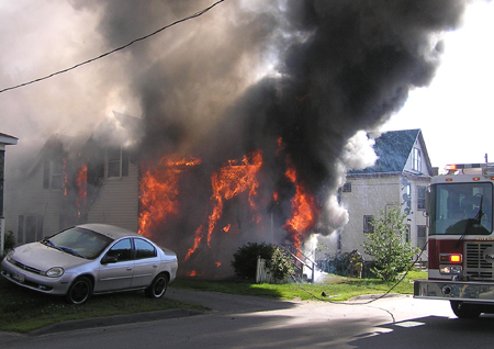 A house on Oak Street in Waterville is consumed by fire Tuesday morning.