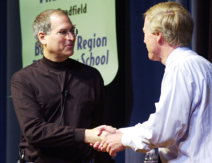 A June 10, 2002, of Steve Jobs, founder and then-president of Apple Computer being greeted by Gov. Angus King as he is introduced at the governor's laptop computer assessment program at Portland High School. Apple iBook laptops were the exclusive laptops bought for the students and Apple provided financial and technical support for the program.