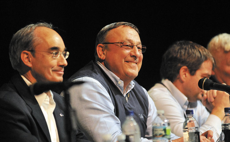 TOWN HALL: Gov. Paul LePage, center, takes questions from the audience Thursday night during a town hall-style meeting at Mount View High School in Thorndike Thursday. The event was part of his continuing Capitol for a Day tour of the state. Seated next to Gov. LePage is state treasurer Bruce Poliquin.