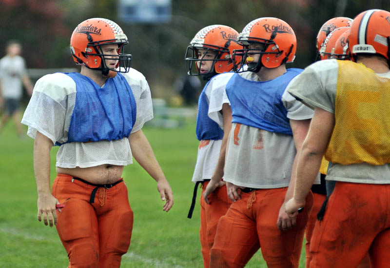 TEACHING POINT: Eric Crawley, left, is one of three captain on the Winslow football team, along with Vitaliano Tantoco and Shane O’Connell. The trio has helped a young team learn the ropes.