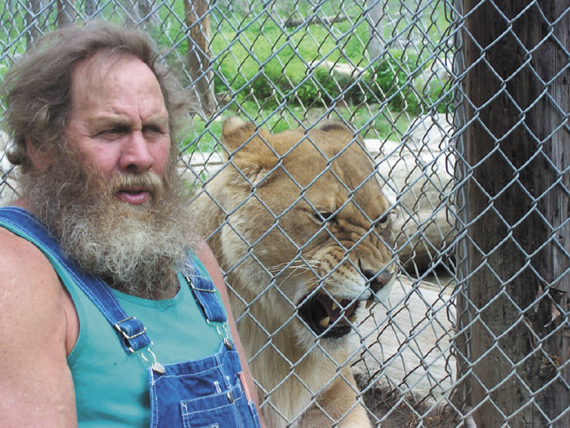 MAN AND CAT: Bob Miner poses with Lilyannah, an African lion who lives at the DEW Animal Kingdom and Sanctuary in Mount Vernon. Miner says the exotic animals he keeps at his private park attract approximately 3,000 people a summer. Maine and Rhode Island are the only New England states not to ban possession of exotic animals.