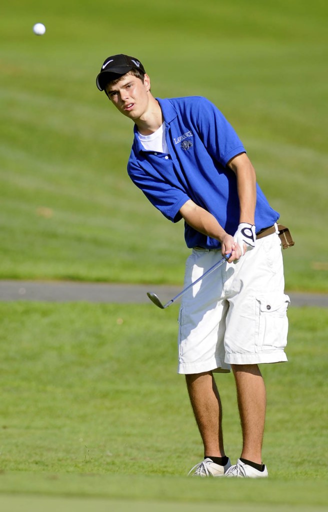 Lawrence High School's Nick Noiles chips Monday during the state golf tournament in Vassalboro.