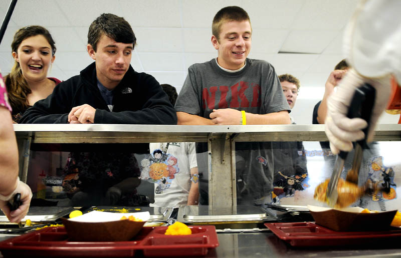 Gardiner Area High School students line up Wednesday for fresh roasted chicken at the school's cafeteria during the Maine Harvest Lunch. Chicken and apples from local farmers were offered to students.