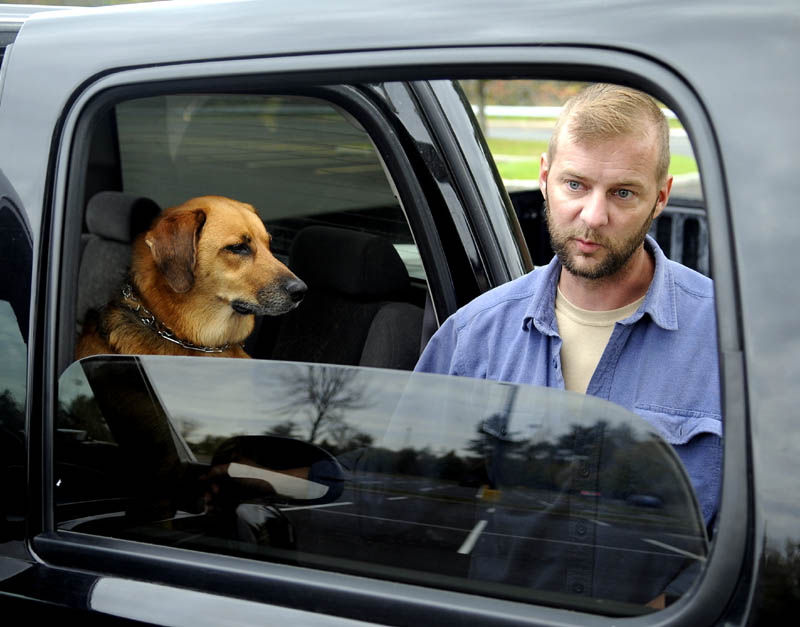 MAN'S BEST FRIEND: Aaron Rollins, a disabled veteran, is living in his truck in Augusta to be with his dog.