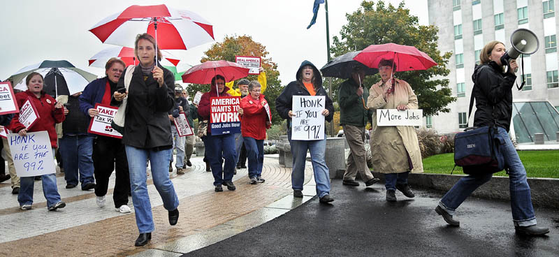Union members from across Maine march Thursday out of the State House in Augusta during a rally for jobs. About 50 people affiliated with Maine labor unions met at the Capitol before marching to the Muskie Federal Building to show support for President Barack Obama’s jobs bill.