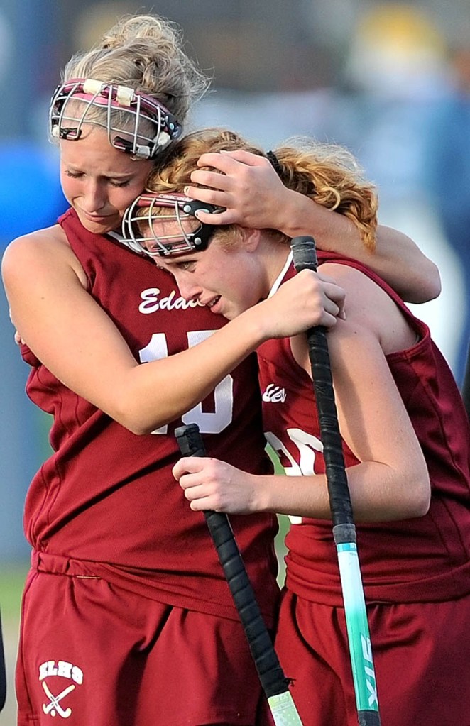 Staff photo by Michael G. Seamans Edward Little High School's Danielle Demers, 15, comforts teammate Jordan Tate, 20, after losing to Lawrence High School 2-0 in the Eastern A quarterfinals game at Lawrence High School in Fairfield Tuesday.
