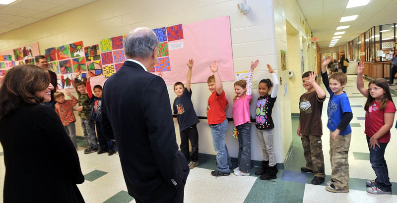 BIG HELLO: Second-grade students wave to former Sen. George Mitchell and his sister Barbara Atkins during a tour of the George Mitchell Elementary School Friday in Waterville.