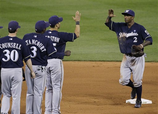 Milwaukee Brewers' Craig Counsell (30), Yuniesky Betancourt (3), Jerry Hairston Jr. and Nyjer Morgan (2) celebrate after Game 4 of baseball's National League championship series against the St. Louis Cardinals Thursday, Oct. 13, 2011, in St. Louis. The Brewers won 4-2. (AP Photo/Charles Rex Arbogast)
