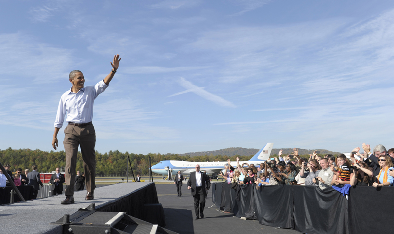 President Barack Obama greets people upon his arrival at Asheville Regional Airport in Fletcher, N.C., today at the beginning of a three-day bus tour promoting the American Jobs Act.