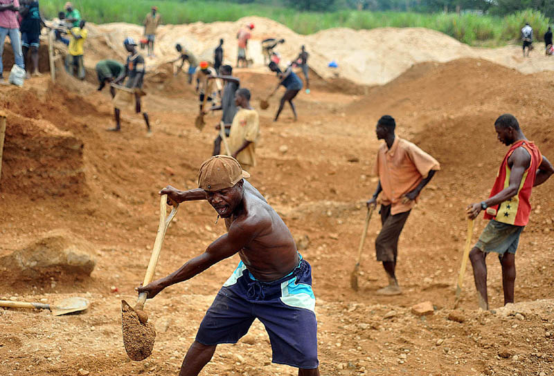 Freddie, a former rebel soldier, shovels gravel as part of the mining operation at the Number 11 diamond mine in the outskirts of Koidu City in Sierra Leone. The former government mine has been sifted through several times. It was handed over to the former rebels to keep them too busy to commit crimes.