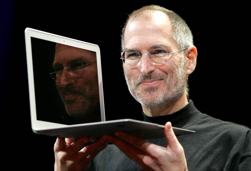 In this Jan. 15, 2008, file photo, Apple CEO Steve Jobs holds up the new MacBook Air after giving the keynote address at the Apple MacWorld Conference in San Francisco. Apple on Wednesday, Oct. 5, 2011 said Jobs has died. He was 56.