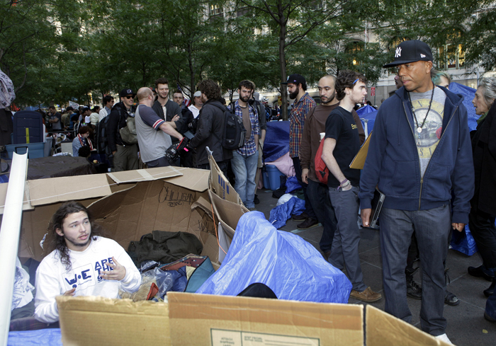Hip hop mogul Russell Simmons, right, listens to a protester at the camp for the Occupy Wall Street demonstration in New York on Sunday.