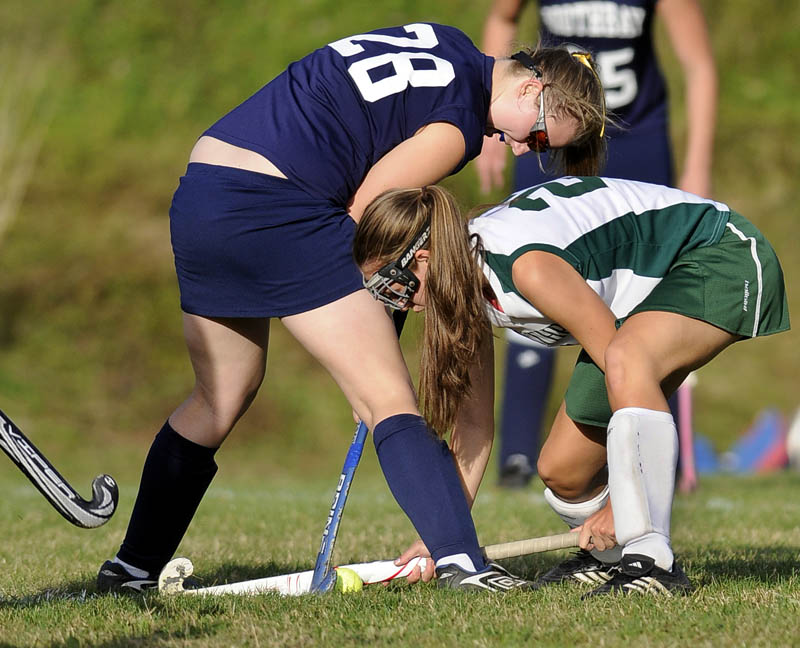 OUT OF MY WAY: Winthrop High School’s Jess Ames, right, drives the ball between the legs of Boothbay High School’s Jess Murray during Tuesday’s game in Winthrop.