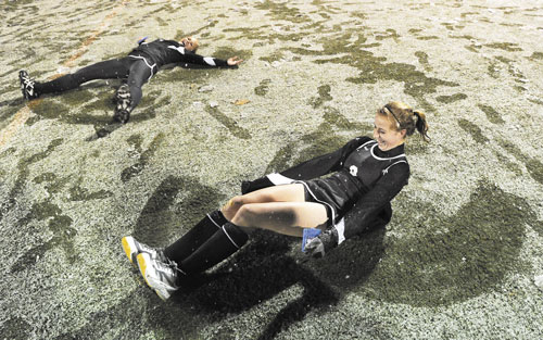 TIME FOR FUN: Skowhegan’s Mikayla Toth, left, and Allison Lancaster, right, celebrate their victory over Marshwood in the Class A field hockey state championship game Saturday at Yarmouth by making snow angels. It was the Indians’ 10th title in the last 11 seasons.