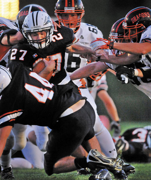 READY TO LEAD: Skowhegan Area High School running back Adam Dusty (27) is tackled by Brunswick High School defenders in the first quarter earlier this season at Skowhegan Area High School. Dusty and the Indians will play Bangor in the regular-season finale for both teams. At stake is a spot in the Pine Tree Conference Class A playoffs with the loser’s season ending.