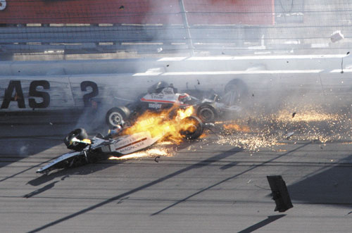 FIERY CRASH: Dan Wheldon, front left, and another driver crash during a wreck that involved 15 cars during the IndyCar Series’ Las Vegas Indy 300 race Sunday at Las Vegas Motor Speedway in Las Vegas. Wheldon died after the crash.