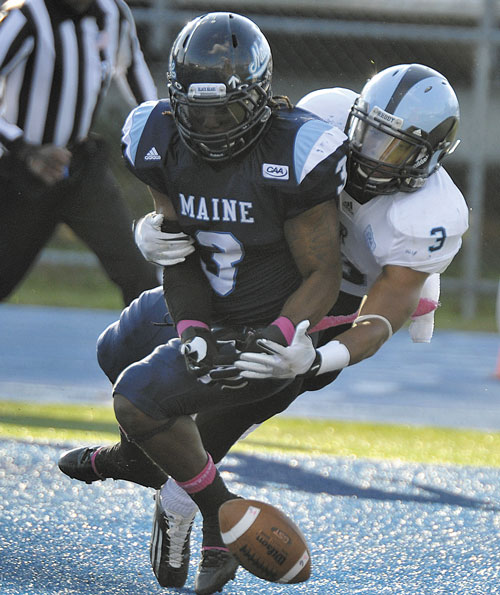 NO CATCH: Maine’s Trevor Coston, front, breaks up a pass intended for Rhode Island’s Brandon Johnson-Farrell, rear, during the second half of Saturday’s game in Orono. The Black Bears won, 27-21.