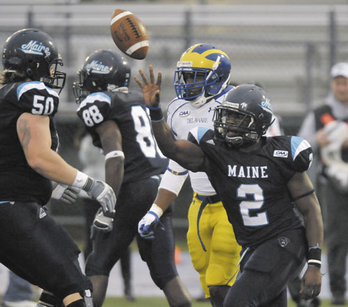 BROWN HONORED: Maine’s Pushaun Brown, right, celebrates a touchdown run with teammate Chris Howley, left, during the second half of the Black Bears’ 31-17 win over Delaware on Saturday in Orono. Brown was named the Colonial Athletic Association Offensive Player of the Week for his 193-yard, three-touchdown performance.