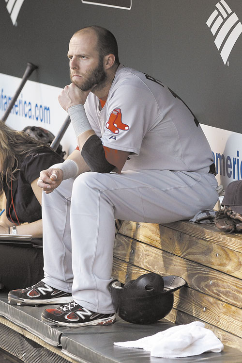TOUGH SEASON: Boston Red Sox second baseman Dustin Pedroia sits in the dugout before a game against the Baltimore Orioles last week in Baltimore.