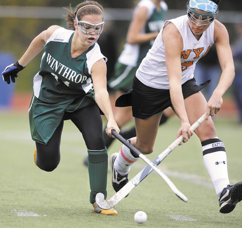FIGHT TILL THE END: Winthrop’s Liz Glover, left, fights NYA’s Katie Millett for control of the ball near midfield during the second half of the Class C state championship game Saturday at Yarmouth High School.