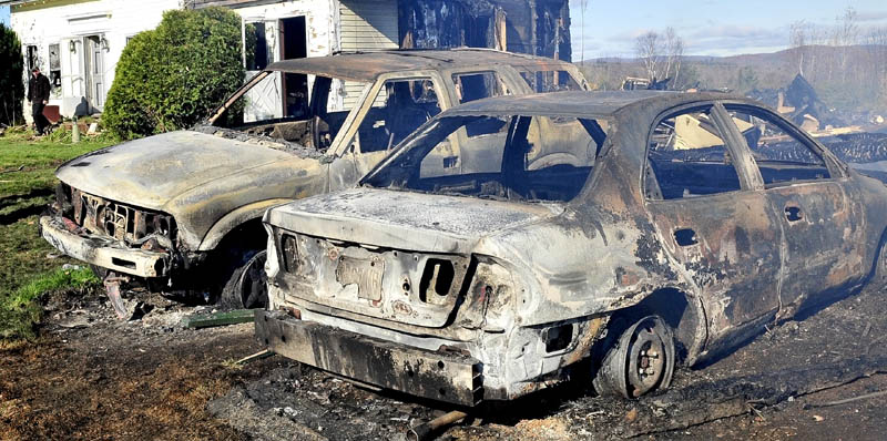 Two cars parked near the home and barn owned by Doug and Mary Lou Harlow were destroyed by a fast moving fire at the residence on the Dore Hill Road in Athens Tuesday evening.
