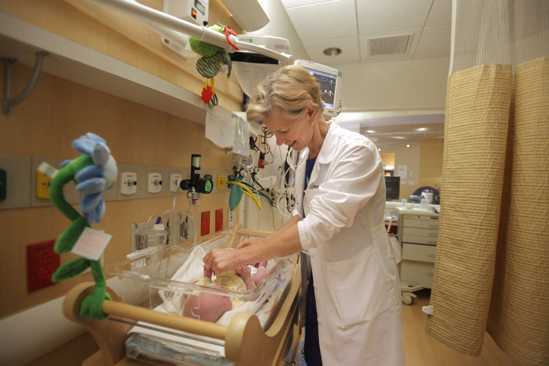 Dr. Brenda Medlin, M.D., examines a baby being treated for withdrawal of opiates at Maine Medical Center in Portland.