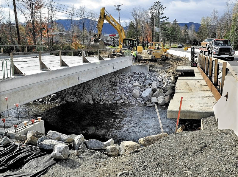 BYPASS: A truck passes over a temporary bridge Monday as workers with Jordan Excavation build up the roadway to the new replacement bridge over Brackett Brook in Carrabassett Valley. The bridge washed out during Tropical Storm Irene in August.