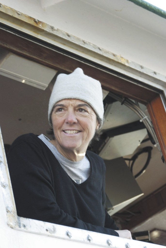 FISHERMAN: Capt. Linda Greenlaw looks out a window while docked at the Portland Fish Exchange in this Nov. 3, 2010, file photo.