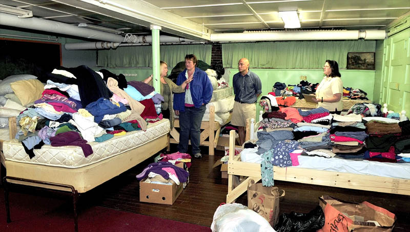 SHELTER FROM THE STORM: Members of the Waterville Area Homeless Action Group tour a dormitory filled with donated beds and clothing collected to meet the needs of homeless at the First Baptist Church in Waterville. From left are Amy Przytulski, Jen Reed, Michael Roy and the Rev. Arlene Tully.