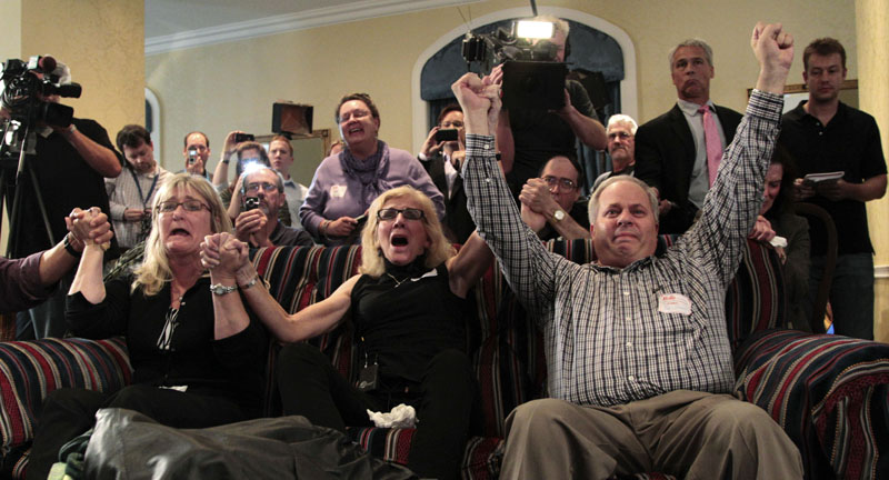 JUBILATION: Supporters of Amanda Knox react as they watch a television news broadcast about her successful appeal verdict Monday in a hotel suite in Seattle.
