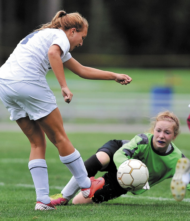ON GOAL: Madison’s Melissa White takes a shot on Monmouth’s Natalie Young during a game earlier this season. The Bulldogs, who won the MVC title Thursday, earned the No. 2 seed in the Western C girls soccer playoffs.