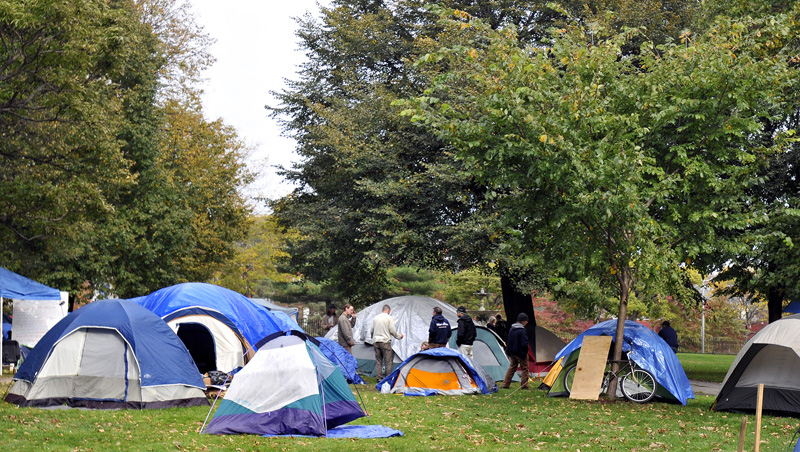 Occupy Maine reorganizes its tents this afternoon in response to a chemical bomb that exploded on the Congress Street side of Lincoln Park early Sunday morning.