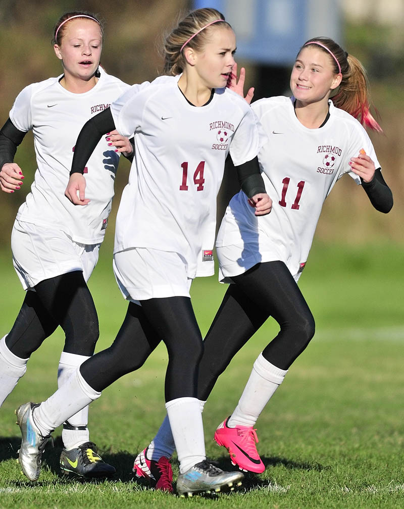 Noell Acord, left, Amber Loon and Micheala Lewis celebrate after a Richmond goal by their teammate Saige Strout during a game on Friday afternoon in Richmond.