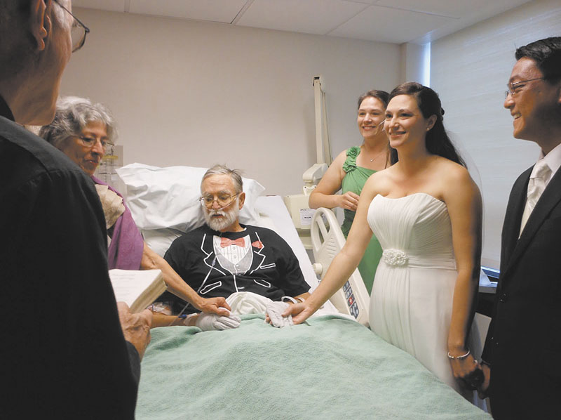 Brian Rines kept his promise to give his daughter away at her wedding recently, despite being stricken with pneumonia and leukemia. MaineGeneral Medical Center staff decorated the room in Augusta, and the bride and groom exchanged vows at Rines’ bedside. From left are the Rev. Richard Johnson; Nancy Rines, mother of the bride; Rines, a forensic psychologist and former Gardiner mayor; Emily Rines Feeley, sister and matron of honor; bride Sarah Rines and groom Philip Javier-Wong.