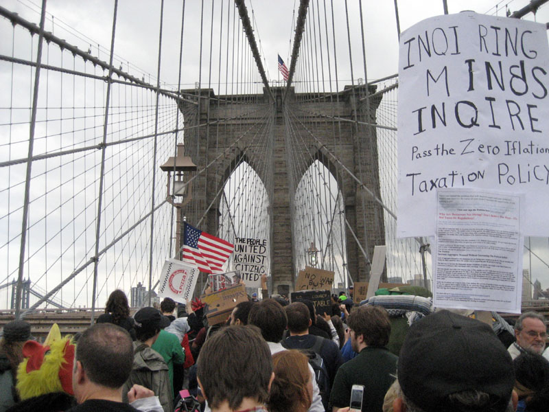VOICING THEIR OPINION: The large group of protesters who camped out on Wall Street for the past two weeks march across the Brooklyn Bridge roadway before being halted by police Saturday in New York. Police arrested 700 protesters Saturday.