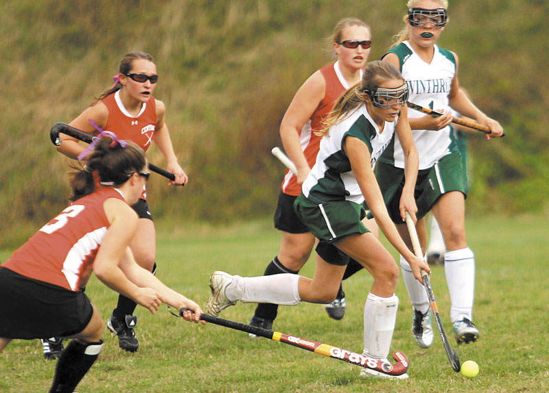 HEADING IN THE RIGHT DIRECTION: Winthrop High School’s Emmah Spahr, second from right, pushes the ball past Central High School’s Tabby Goldsmith, left, during the first half of a Class C semifinal field hockey game Saturday in Winthrop. Winthrop won 3-0.