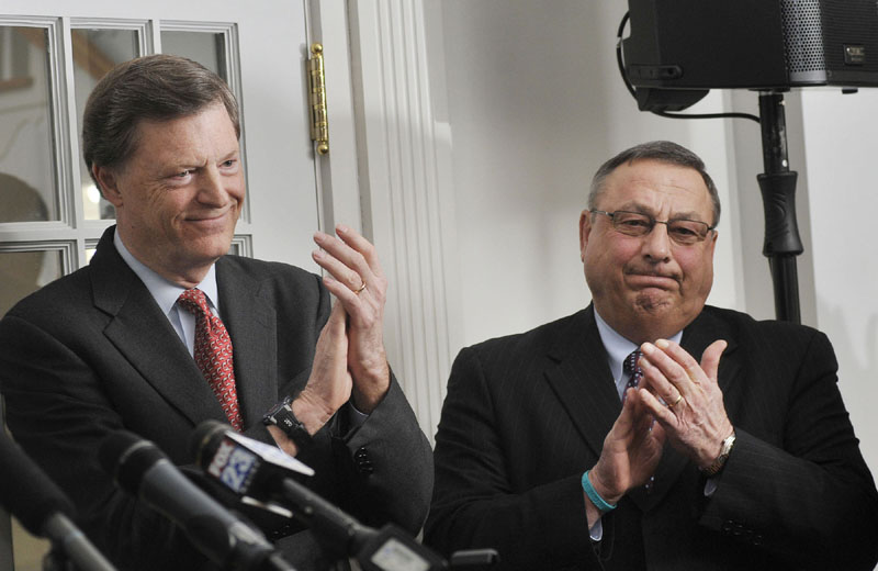 BRAVO: Former Gov. John McKernan, left, and Governor Paul Lepage clap as the results of the first-ever statewide fundraising effort in support of Maine's Community Colleges are announced at Southern Maine Community College in South Portland on Monday.