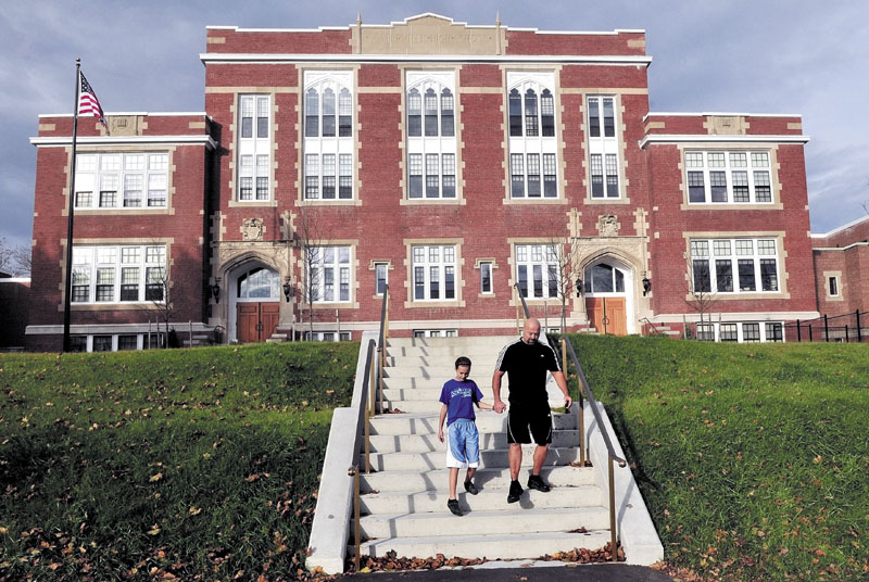 REVIVED: Anika and David Elias walk down the front steps of the renovated Gilman Place in Waterville on Tuesday.