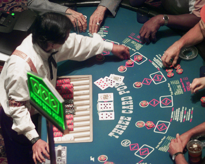 Gamblers will soon be able to place their bets on blackjack, craps and other table games in Maine. In this photo, a casino employee deals a game of poker at Station Casino in Kansas City, Mo.
