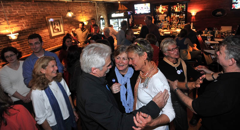 Mayor-elect Karen Heck, center, celebrates with supporters at 18 Below Raw Bar in Waterville Tuesday night after poll results filtered in.