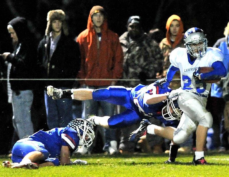 LET’S DO THIS AGAIN: Lawrence High School’s Jake Doolan (25) breaks free from Messalonskee High School defender Kyle Gleason, center, in the first quarter Friday night at Messalonskee High School in Oakland. The Eagles and Bulldogs will meet for the second week in a row, this time in the playoffs.