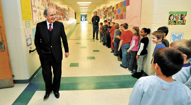 FRIENDLY FACES: Students from Mr. Dolloff's second-grade class say hello to Sen. George Mitchell, left, during a tour of the George Mitchell Elementary School recently in Waterville.
