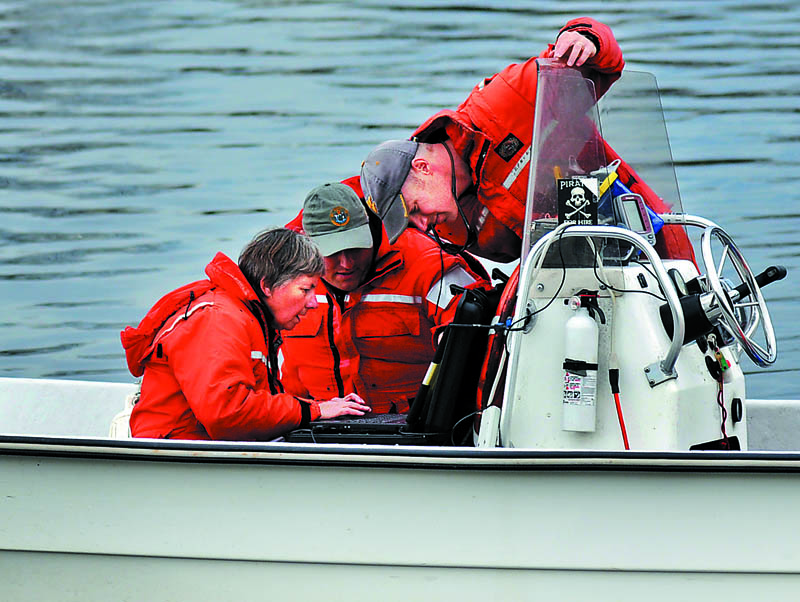 STURGEON HUNTERS: Maine Department of Marine Resources biologists Gail Wipplehauser, left, Jason Valliere and Jason Bartlett search for SNAP Monday on a computer they used to track the fish with a sonar while floating on the Kennebec River between Gardiner and Randolph. The scientists were hoping to determine why the shortnose and Atlantic sturgeon tagged with transmitters had not migrated to their winter terrain in the Kennebec River in Richmond, according to Wipplehauser. “They seem to be roaming this year,” she said of fish that reach up to nine feet in size. The sonar study of shortnose, an endangered species, and Atlantic sturgeon is funded by the National Oceanic Atmospheric Administration, a federal agency.