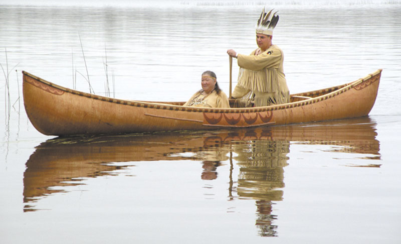 This October 2011 photo provided by the Passamaquoddy tribe shows Chief Joseph Socobasin paddling a birch canoe with his grandmother Joan Dana in Indian Township, Maine. Tribal members built the canoe, a replica of one from the 1800s, using a single piece of birch bark. Though Maine voters rejected a racetrack casino last week, that would have helped bolster the tribe's economy, they are looking to wind, water and land for other means of economic development.