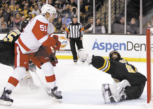 OPENING GOAL: Detroit’s Valtteri Filppula, left, scores on Bruins goalie Tuukka Rask during the first period Friday in Boston. Rask made 29 saves but gave up two goals in three shootout chances.