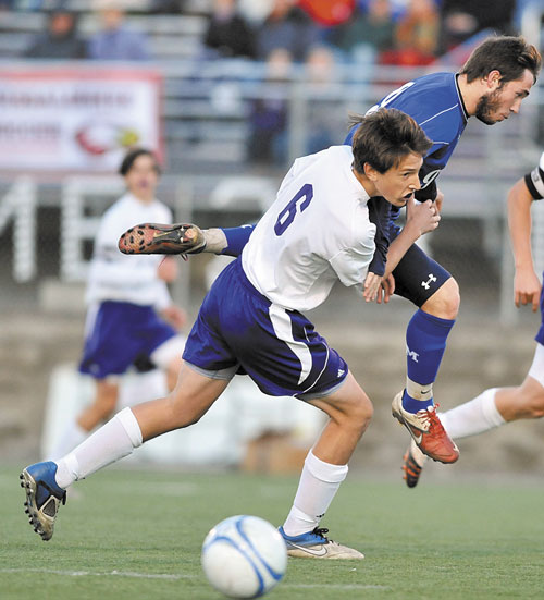Messalonskee High School’s Chris Hall, right, battles for the ball with Hampden Academy’s Sam Lebel in the Eastern Maine Class A boys soccer championship game Wednesday at Hampden Academy. The Eagles will face Windham for the state title on Saturday in Falmouth.