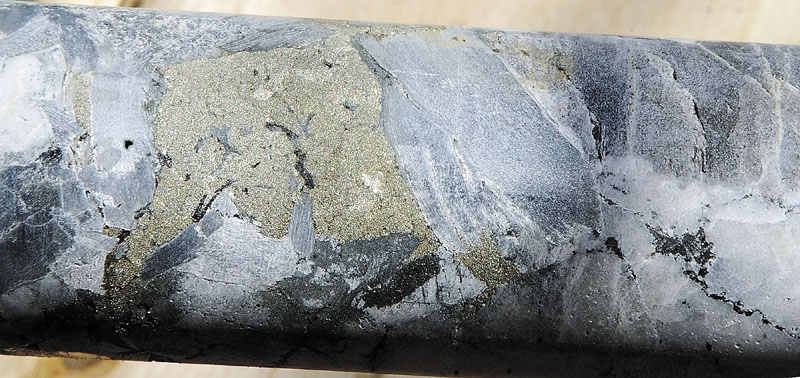 A CLOSER LOOK: A section of pyrite sparkles amidst a core sample of pegmatite taken from a bore hole in Peter Meulendyk’s front lawn Wednesday in Manchester. The core samples will be sent to Columbia University for testing. State geologist Bob Johnston said that pyrite might be a source of arsenic.