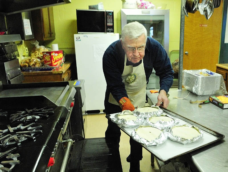 PREPPING FOR A FEAST: Phil McSweeney loads apple pies, for today’s Thanksgiving community dinner, into the oven Wednesday morning at St. Francis Parish Hall in Winthrop. The hall will be open from 11 a.m. to 2 p.m., and Winthrop Rotary will host a free Thanksgiving dinner from 12:30 to 1 p.m. There is no cost and all are welcome.